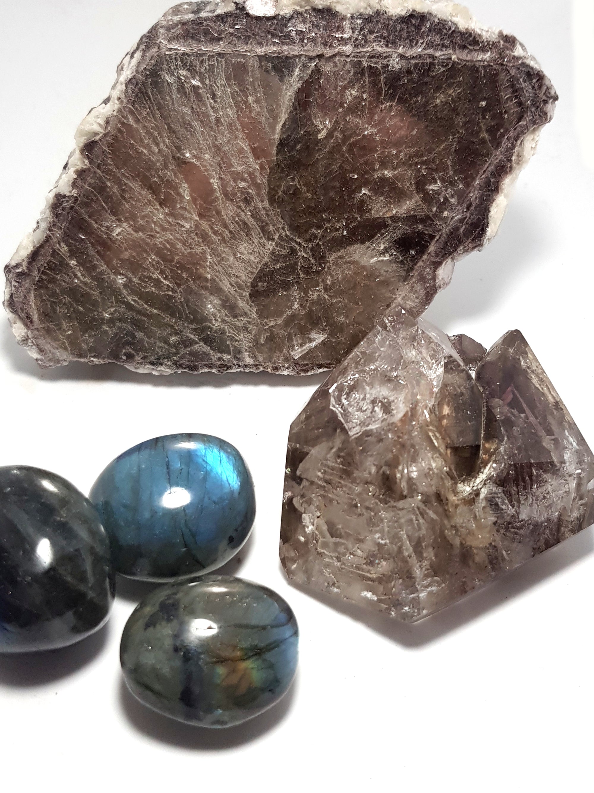 a zoned crystal of lepidolite mica, 3 polished pebbles of labradorite, quartz 