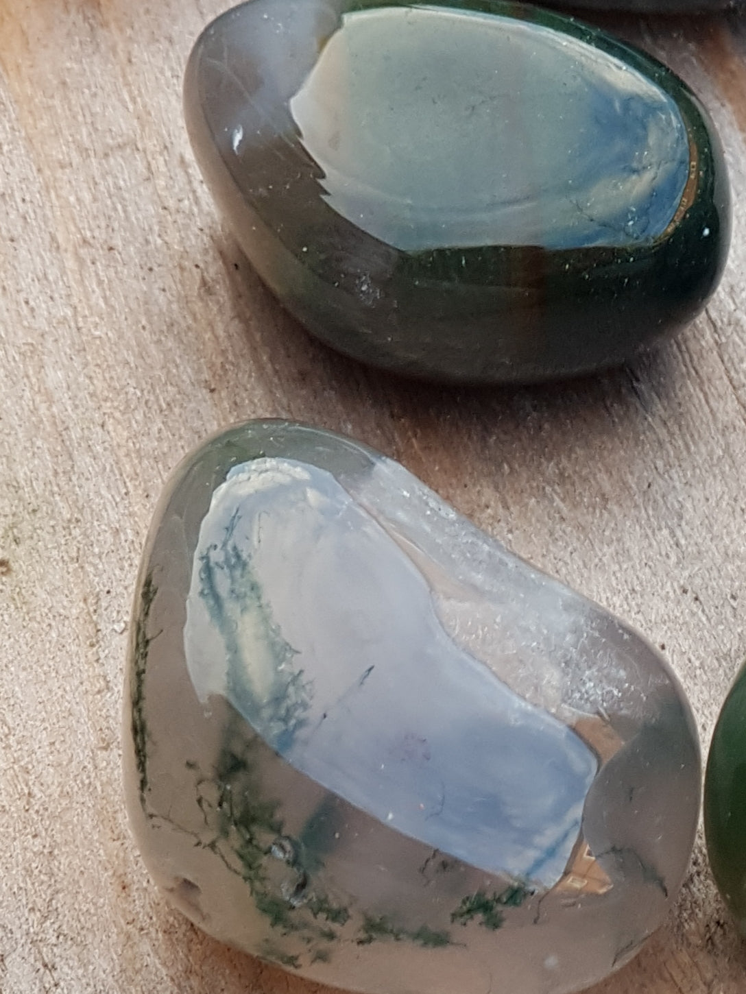 Green moss agate tumblestones. Smooth and polished. Translucent and see through. Have strands of a green material within them