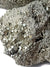 A close up of a chunk of pyrite showing multiple pyritohedral crystals