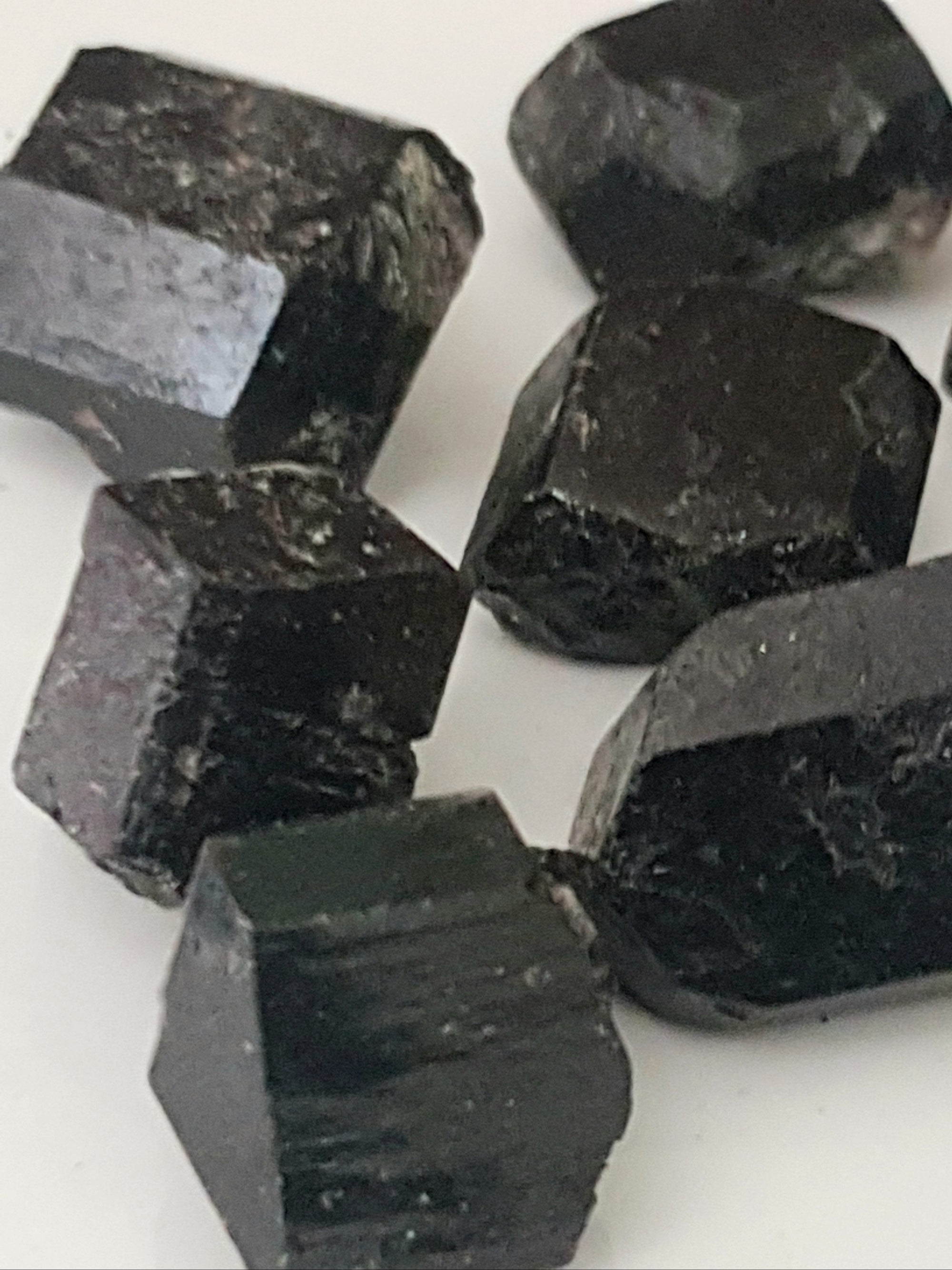 six crystals of black tourmaline. They are prismatic and well formed.