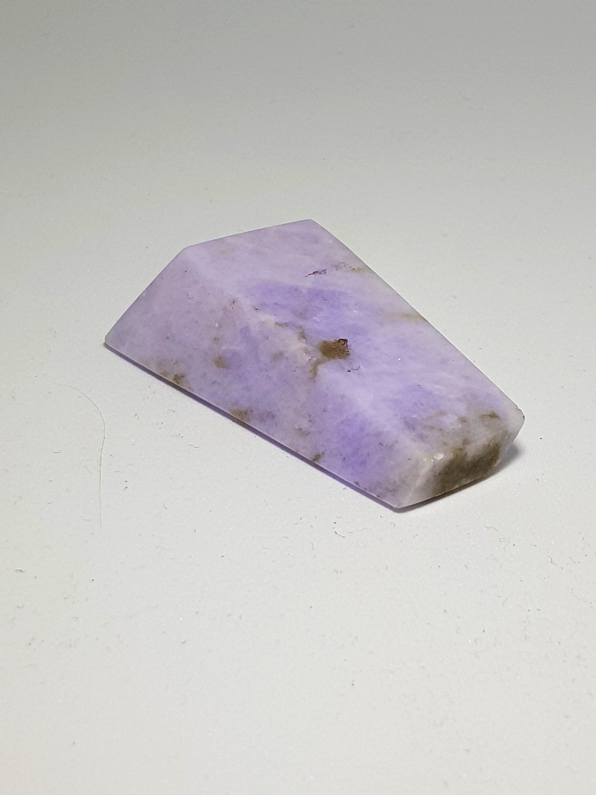 Lavender jadeite (Burma). A small angular freeform of jadeite. The sample is a deep lavender purple, with a few brown inclusions. 