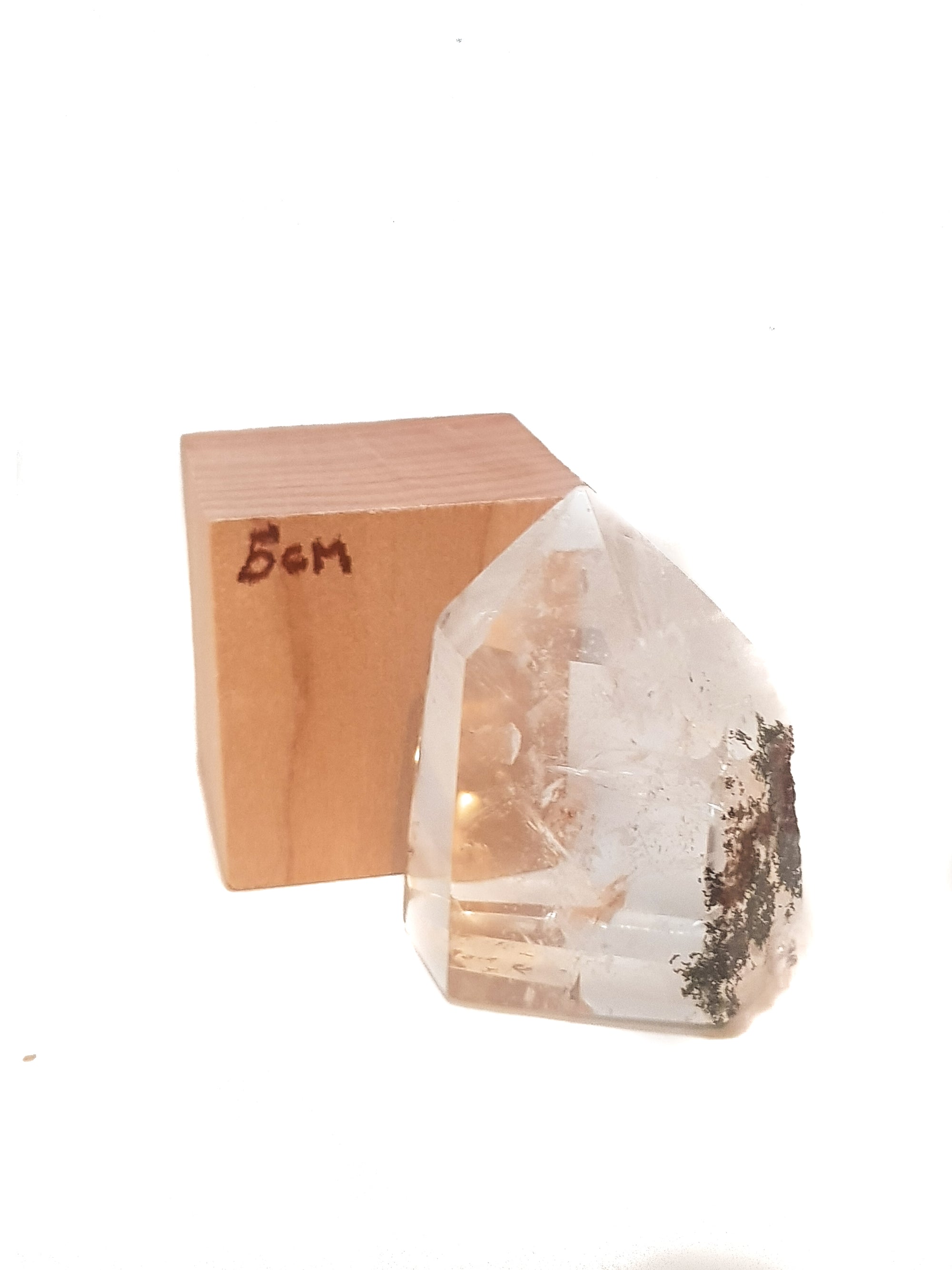 Polished quartz point with carbon inclusions