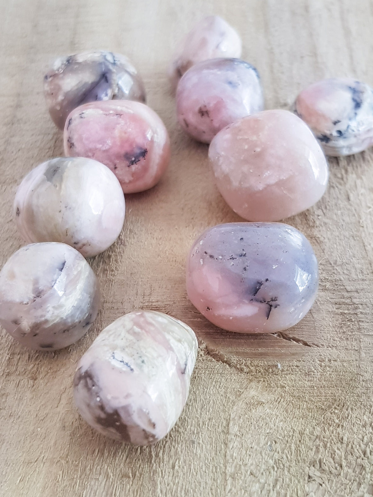 pink opal tumblestones. somne variation of colour from dark pibnk to pastel, some banding and inclusions