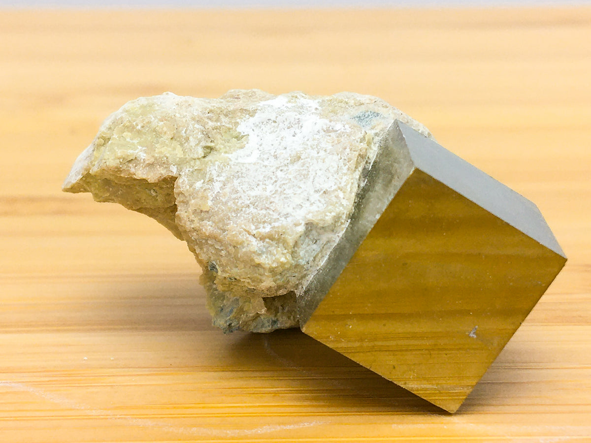 Naturally occurring iron pyrite cubic crystal in matrix