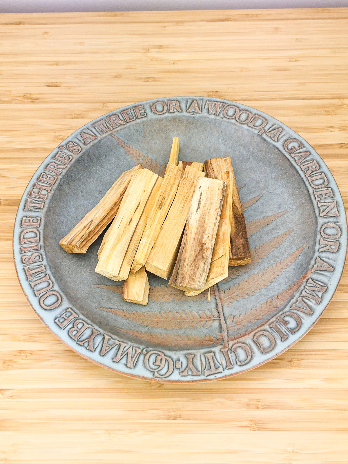 Stick sod Palo Santo (an aromatic wood) on a ceramic plate
