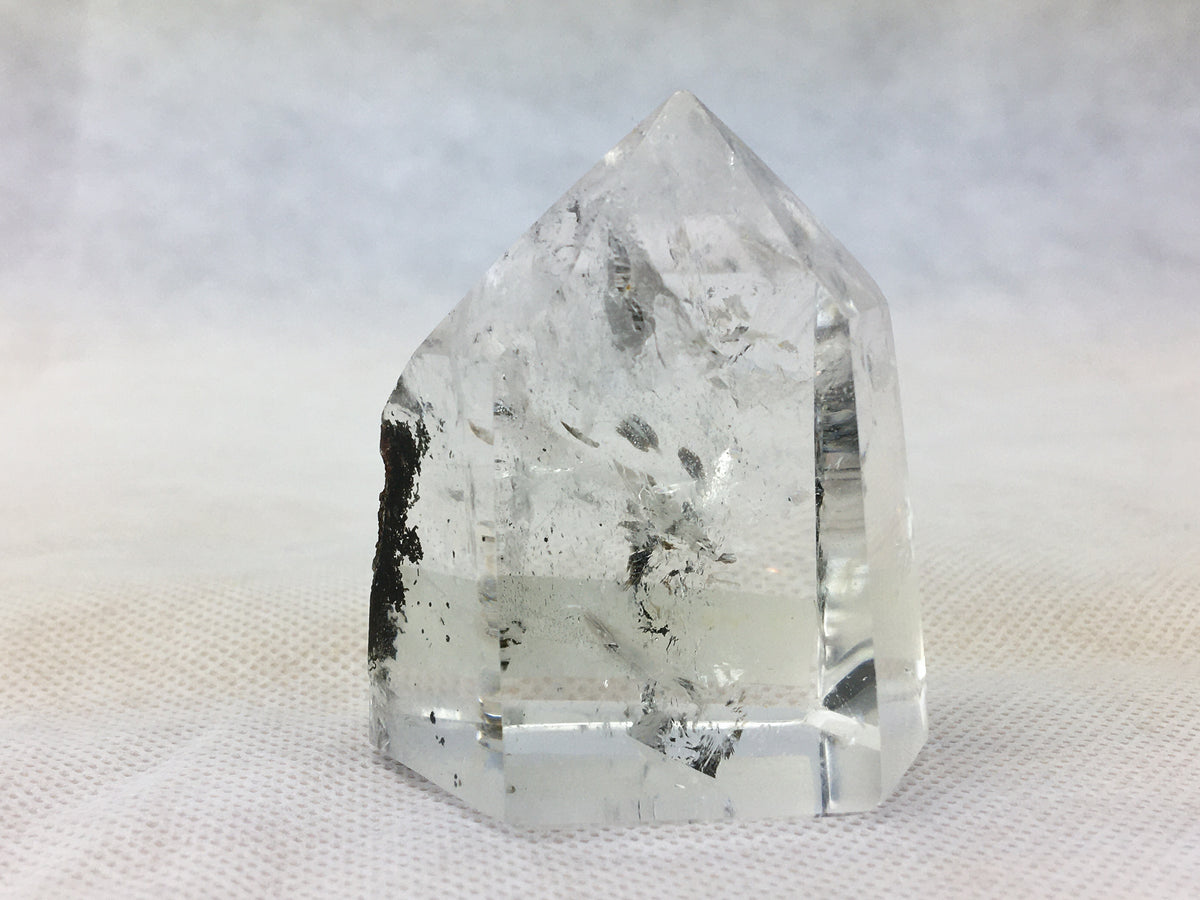 Polished quartz point with carbon inclusions