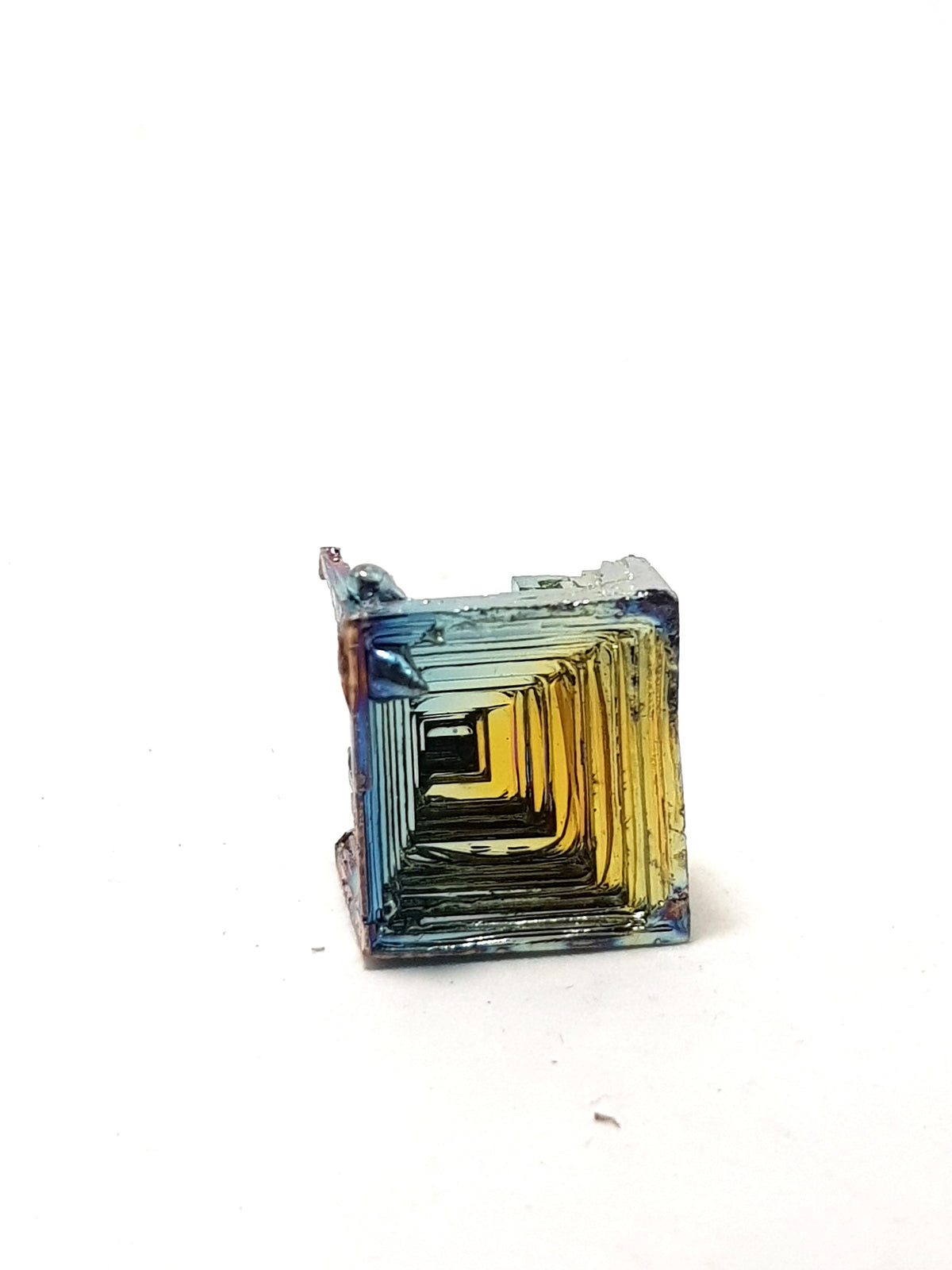 bismuth crystal. square base, shows hoping and golden/blue iridescence