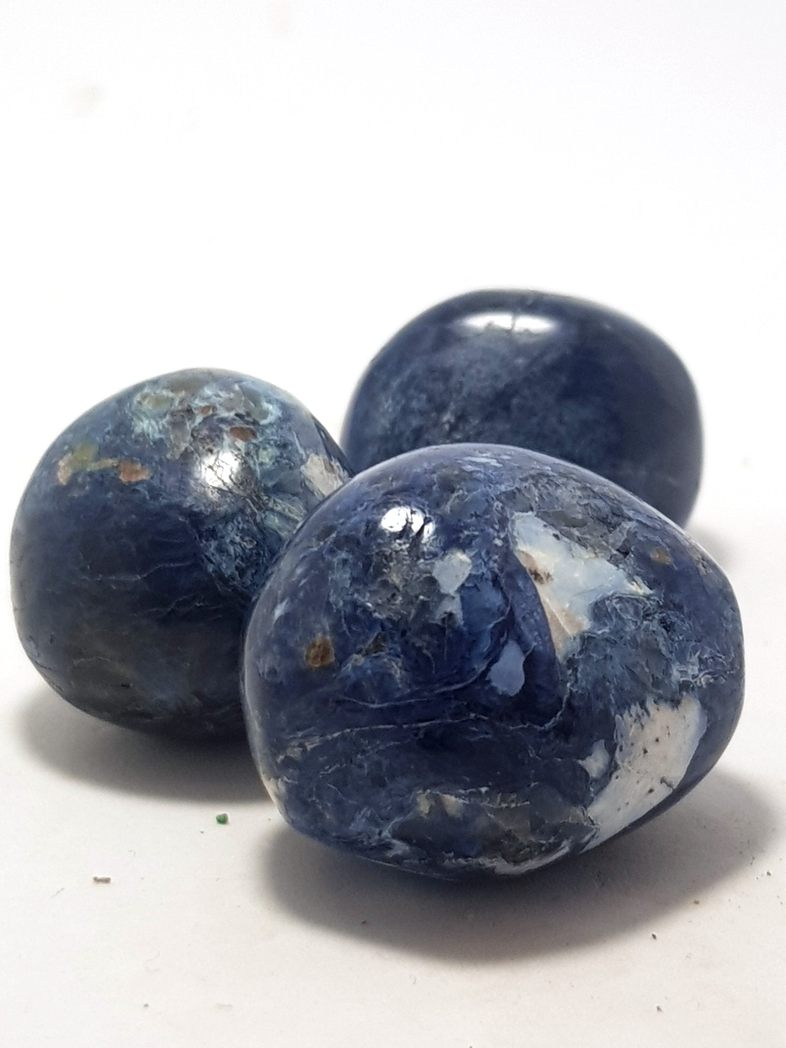 pebbles of dumorterite. They are very blue, they have splotches and swivels of a second white mineral which is included in the stone.