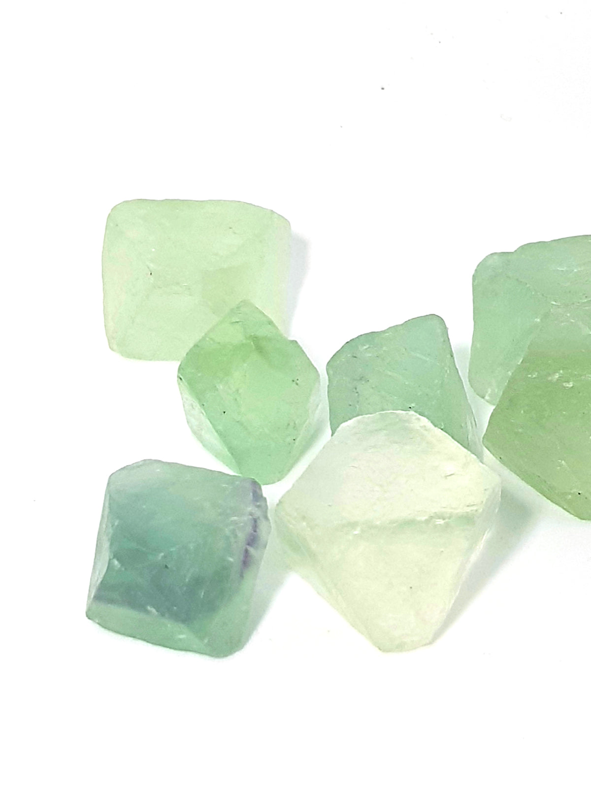 seven natural octohedral crystals of fluorite. They are translucent and range in colour from green to purple. 