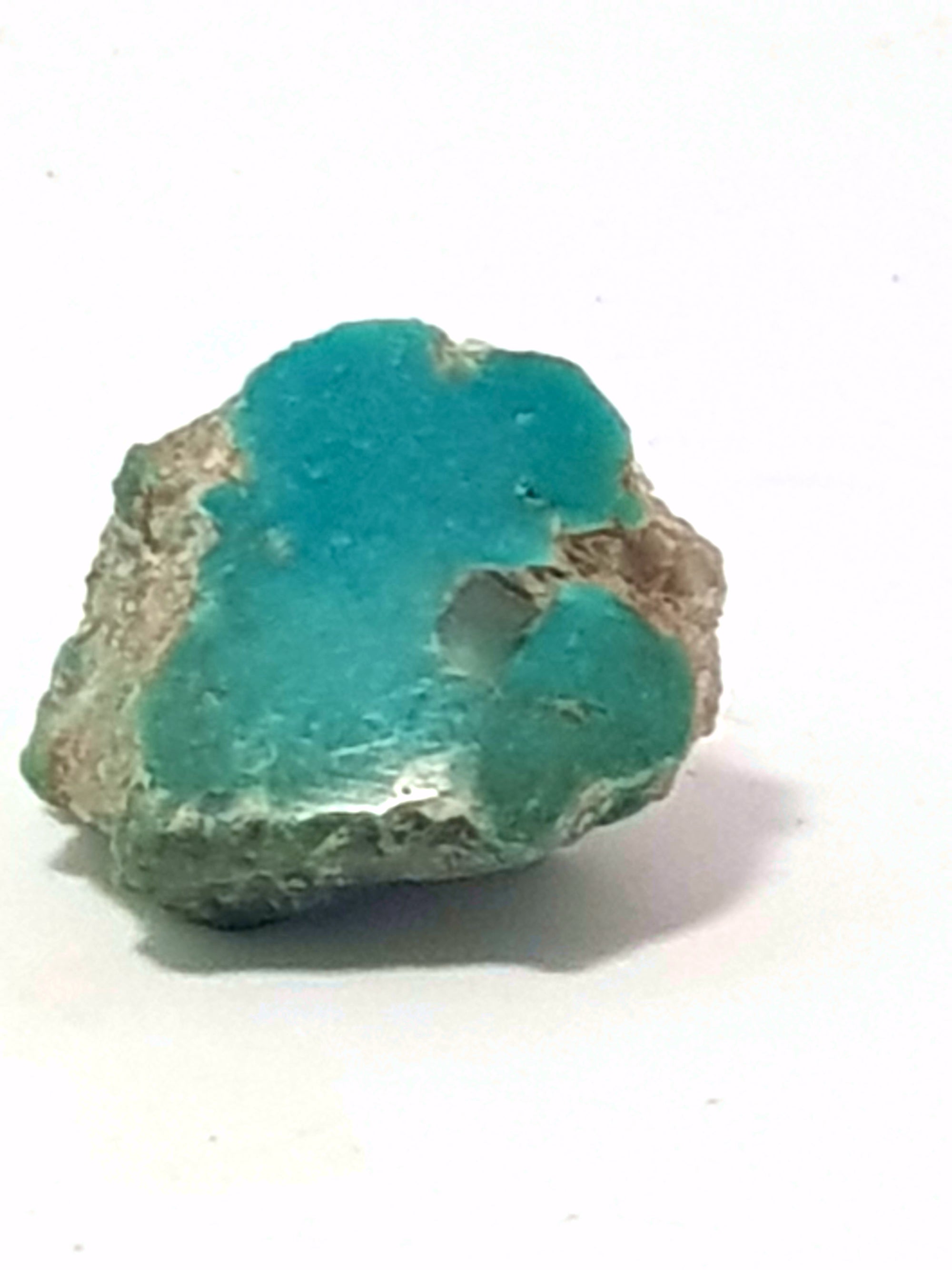 semi polished sample of kingman turquoise. This sample has a fully polished face. The sample is blue green.