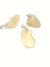 three pieces of libyan desert glass which have a metallic setting on one end turning them into pendants