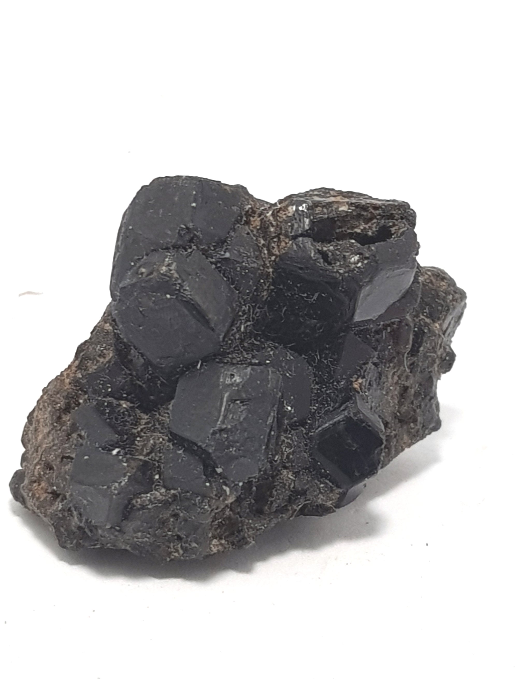 Melanite. Well formed dodecahedral crystals of black garnet. The crystals are relatively large and clustered together.