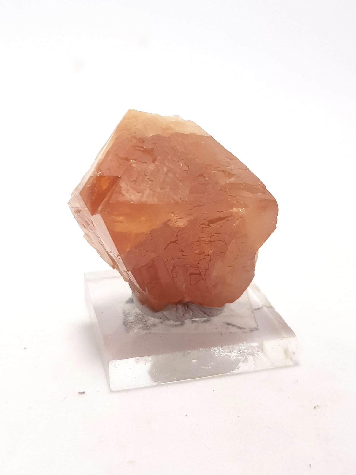 scheelite crystal. It is orange and relatively translucent. It is octahedral.