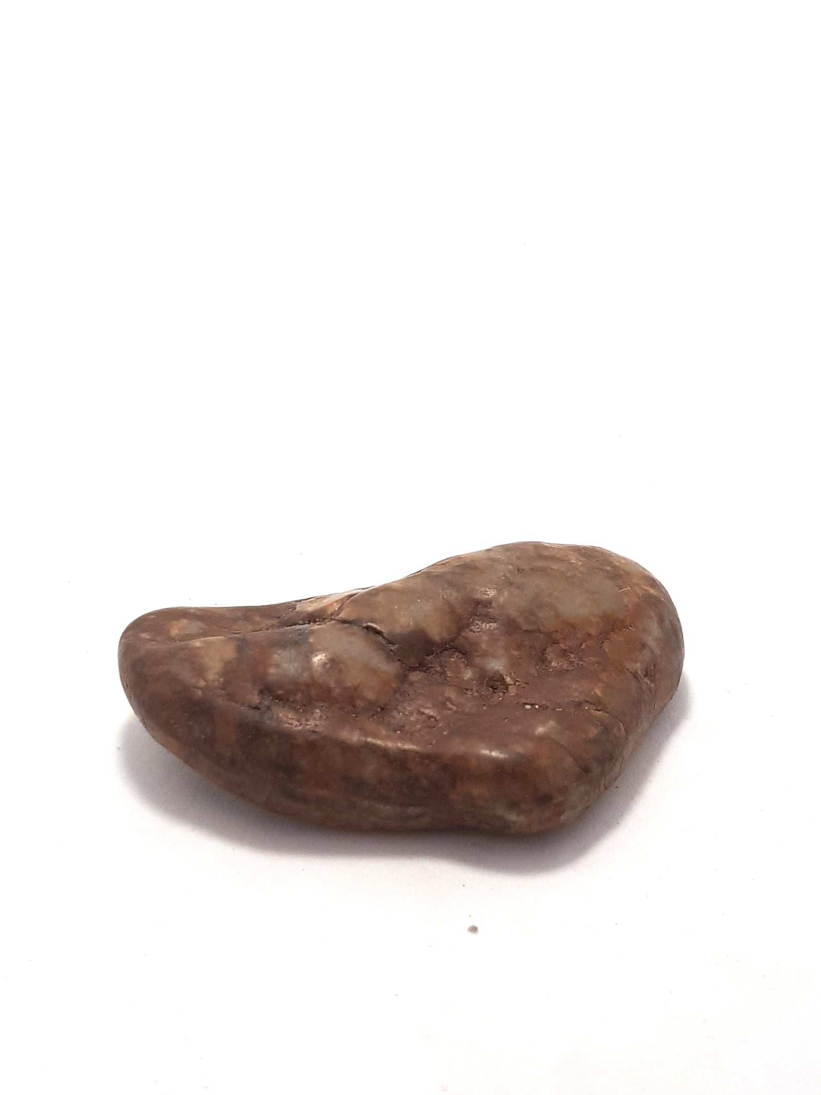 sillimanite. This sample is a rounded pebble. It is predominately beige.