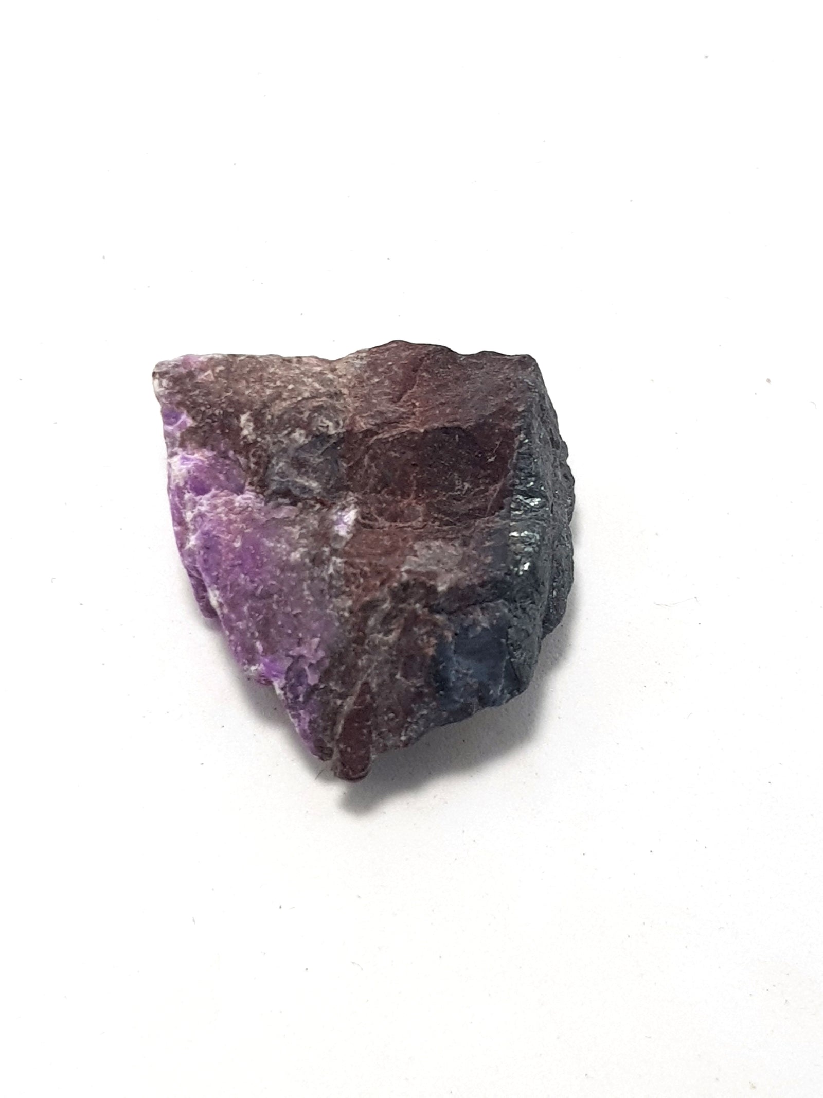 raw sugilite. this consists of a mauve mineral (sugilite) in a  dark grey and brown matrix