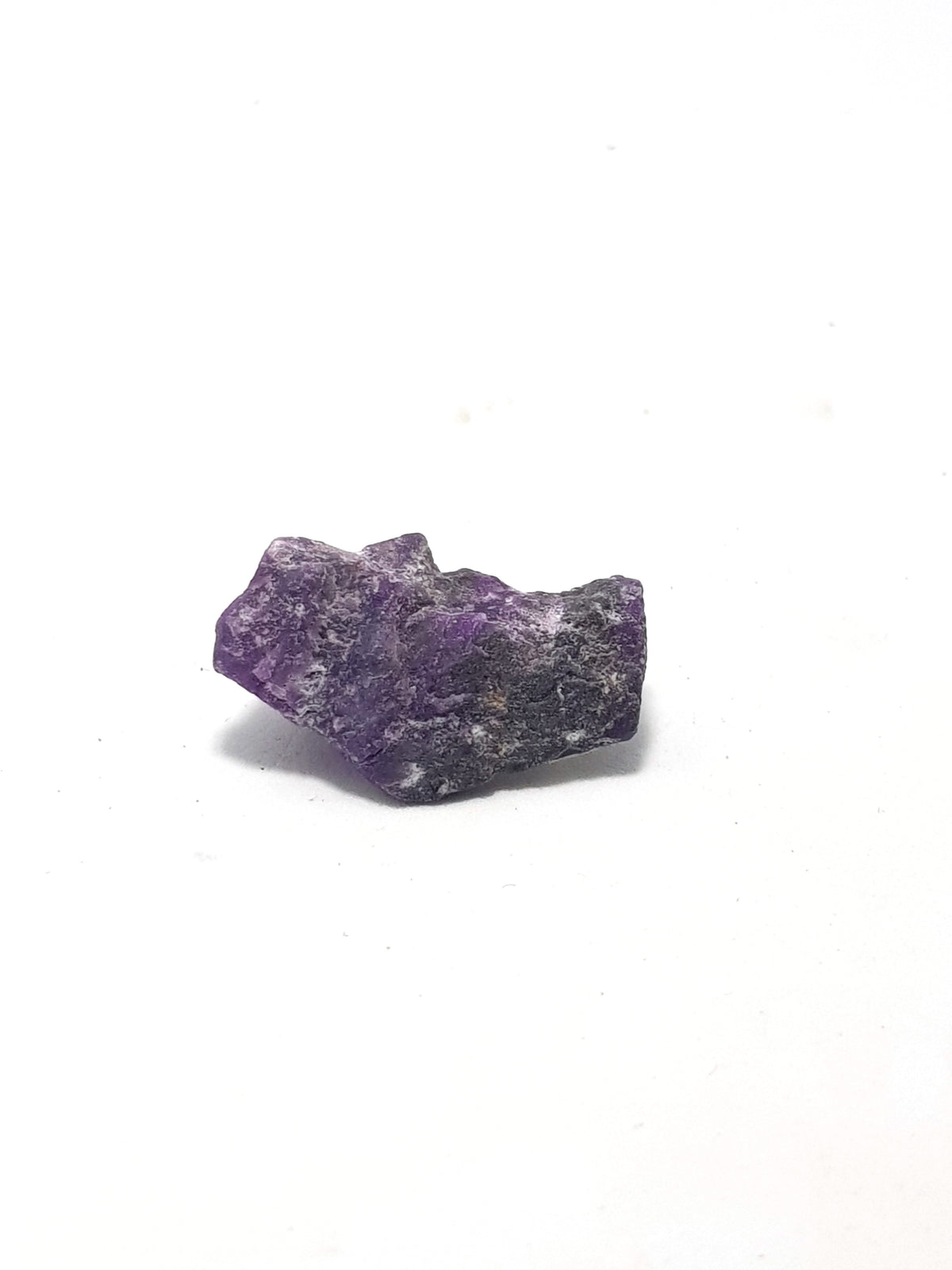 raw sugilite. very purple with a black matrix