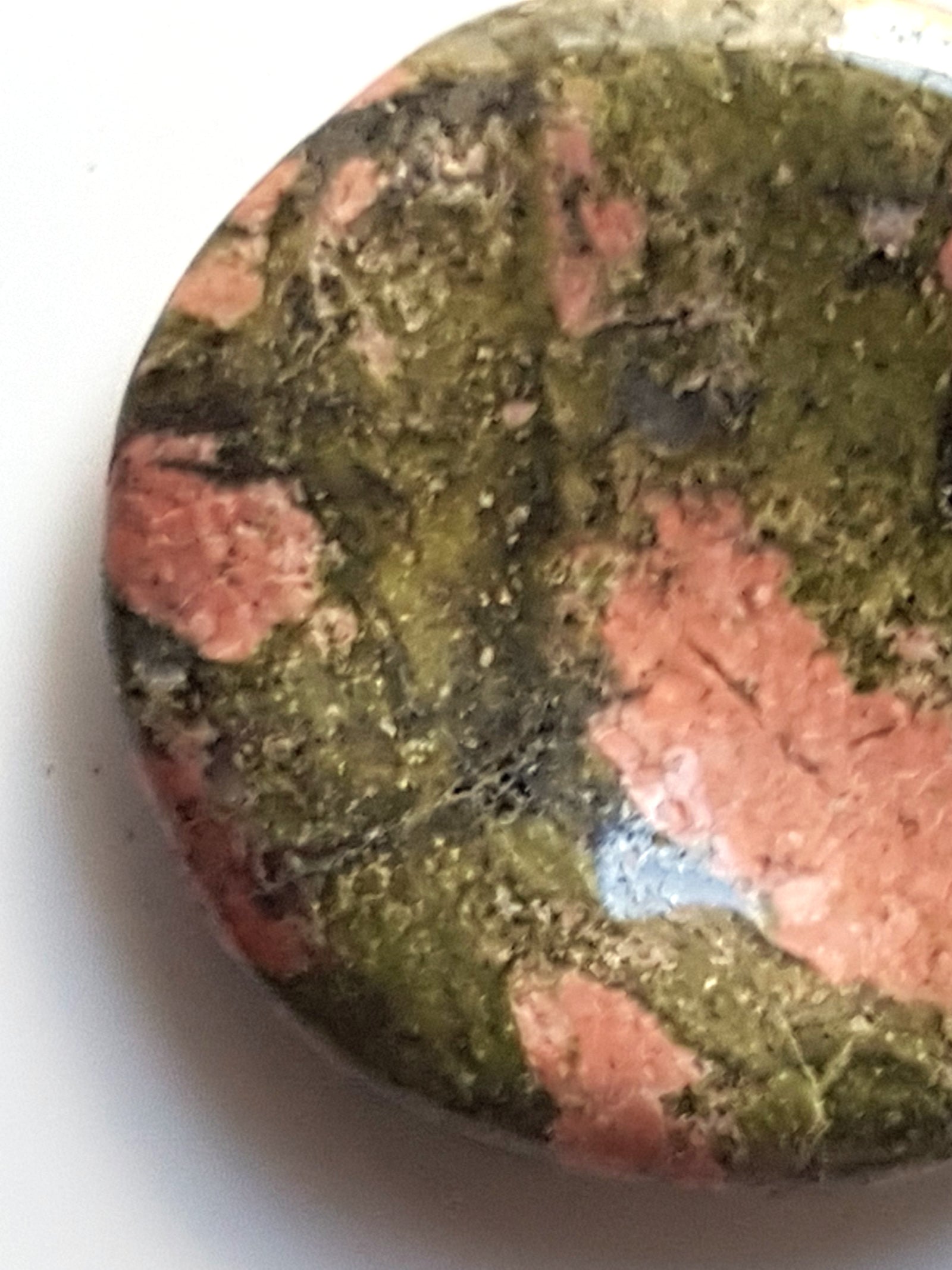 unakite thumbstone. This rock consists of pistachio green crystals of epidote with large orange crystals of orthoclase